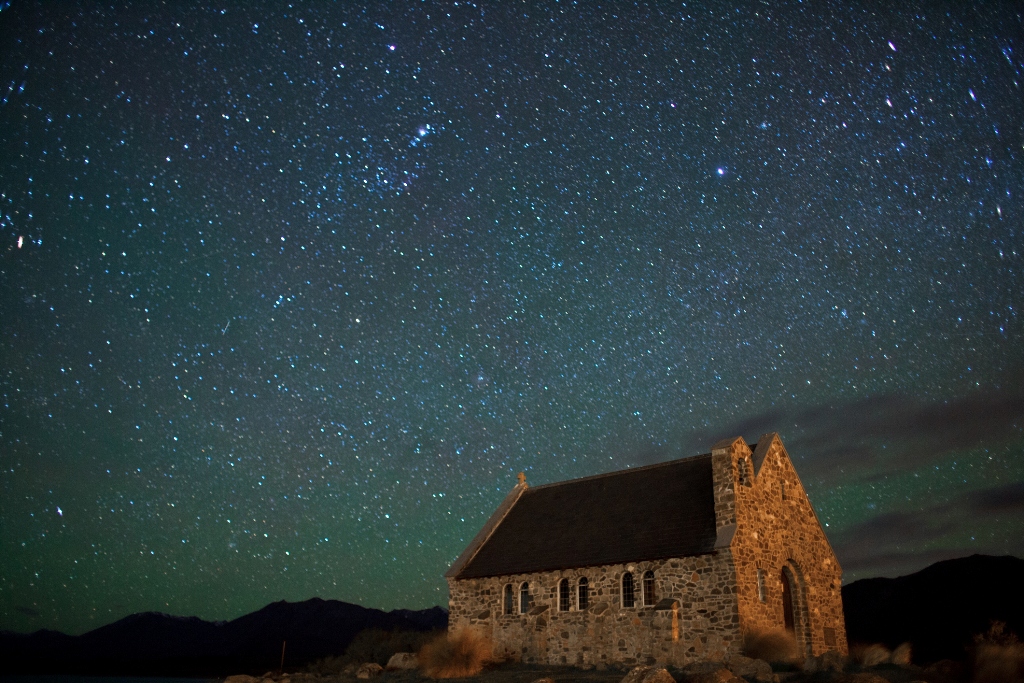 A sky full of stars above a house at Lake Tekapo